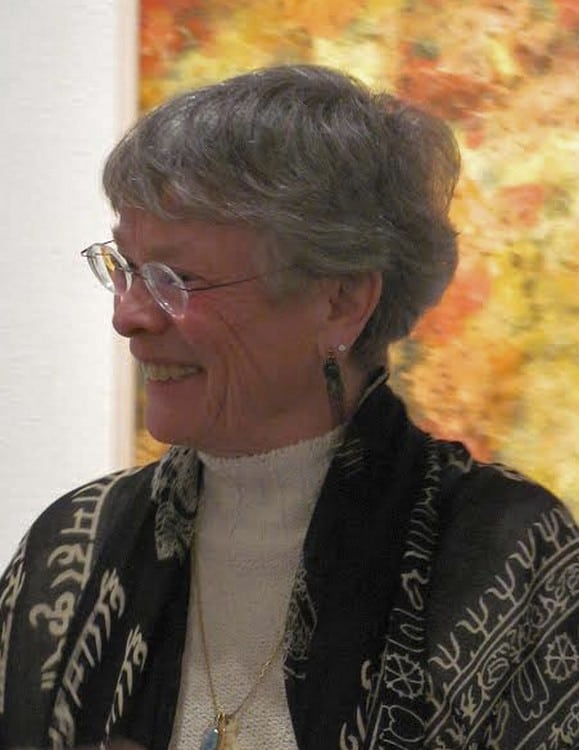 Susan Christie in front of her ink-and-gouache painting on paper, _Sunlight