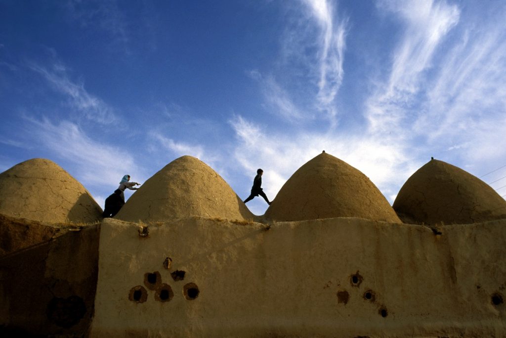 3 Children Playing among the Domed Roofs of Am Al Aboud 